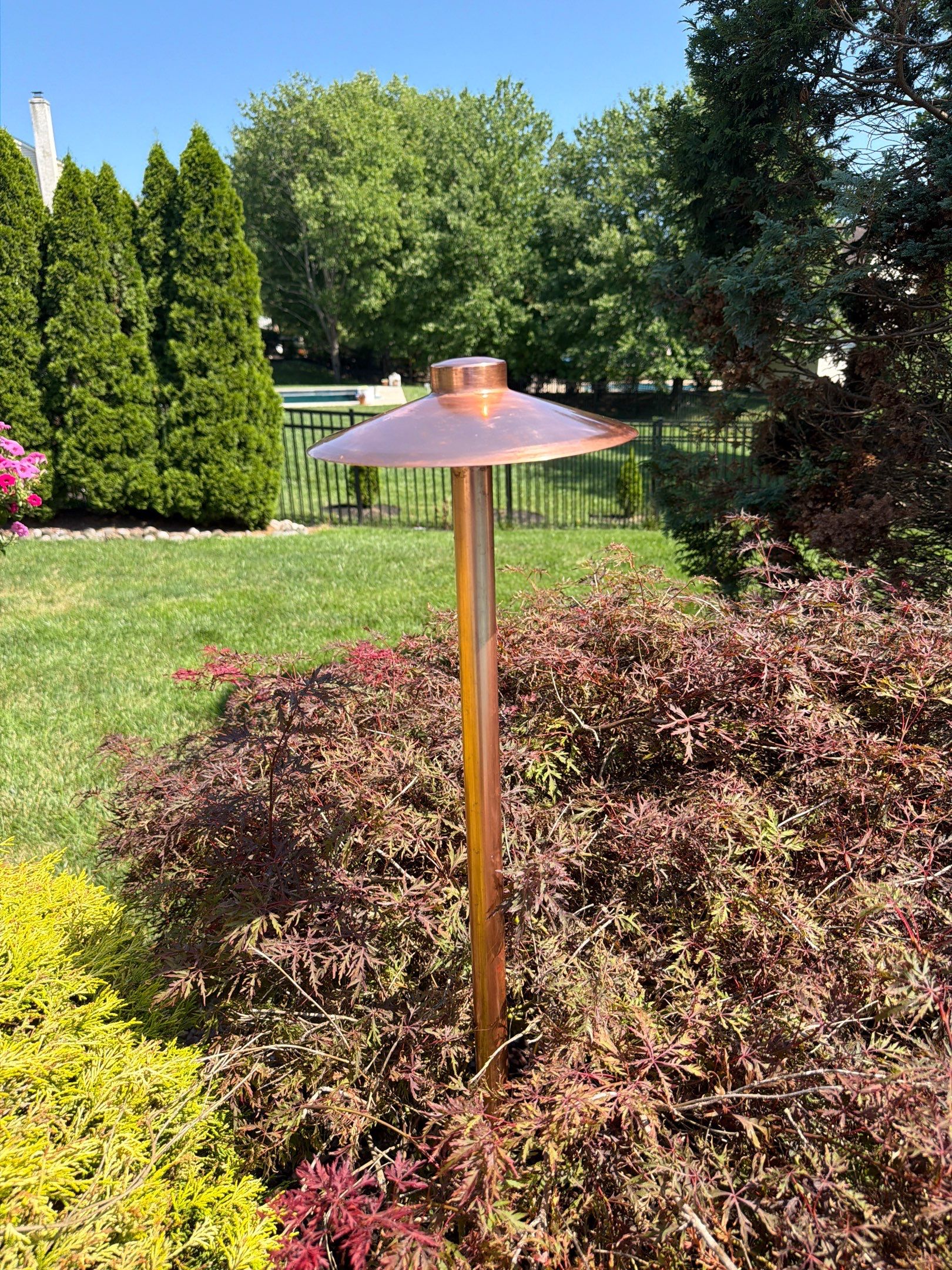 Outdoor lighting fixture with patina removed during restoration